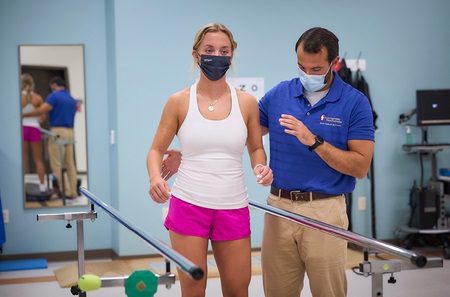 Patient Sophie Borrelli does exercises with the help of Matthew Prusinski, a physical therapist with Penn Therapy & Fitness